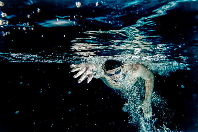 Underwater competitive swimmer swimming freestyle.