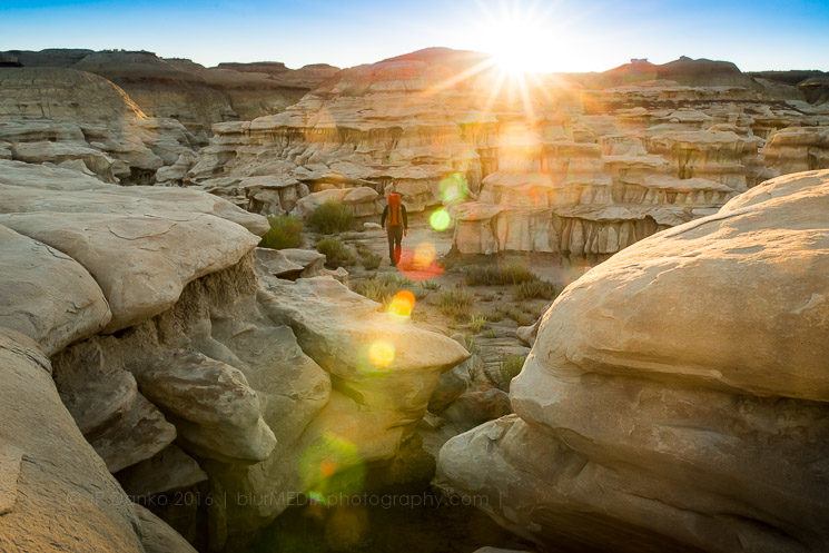 Man (40) hiking in Bisti/De Na Zin Wilderness Area in New Mexico at sunrise.