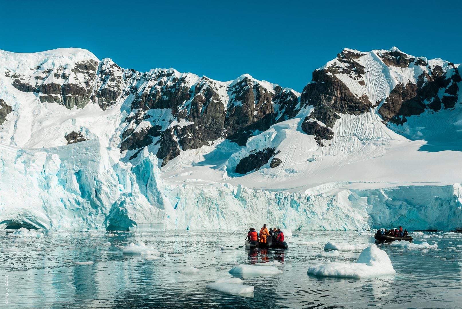 Tourists observing a glacier on the Antarctica, Paradise bay, Antartica.
