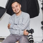 happy photographer in studio with gear