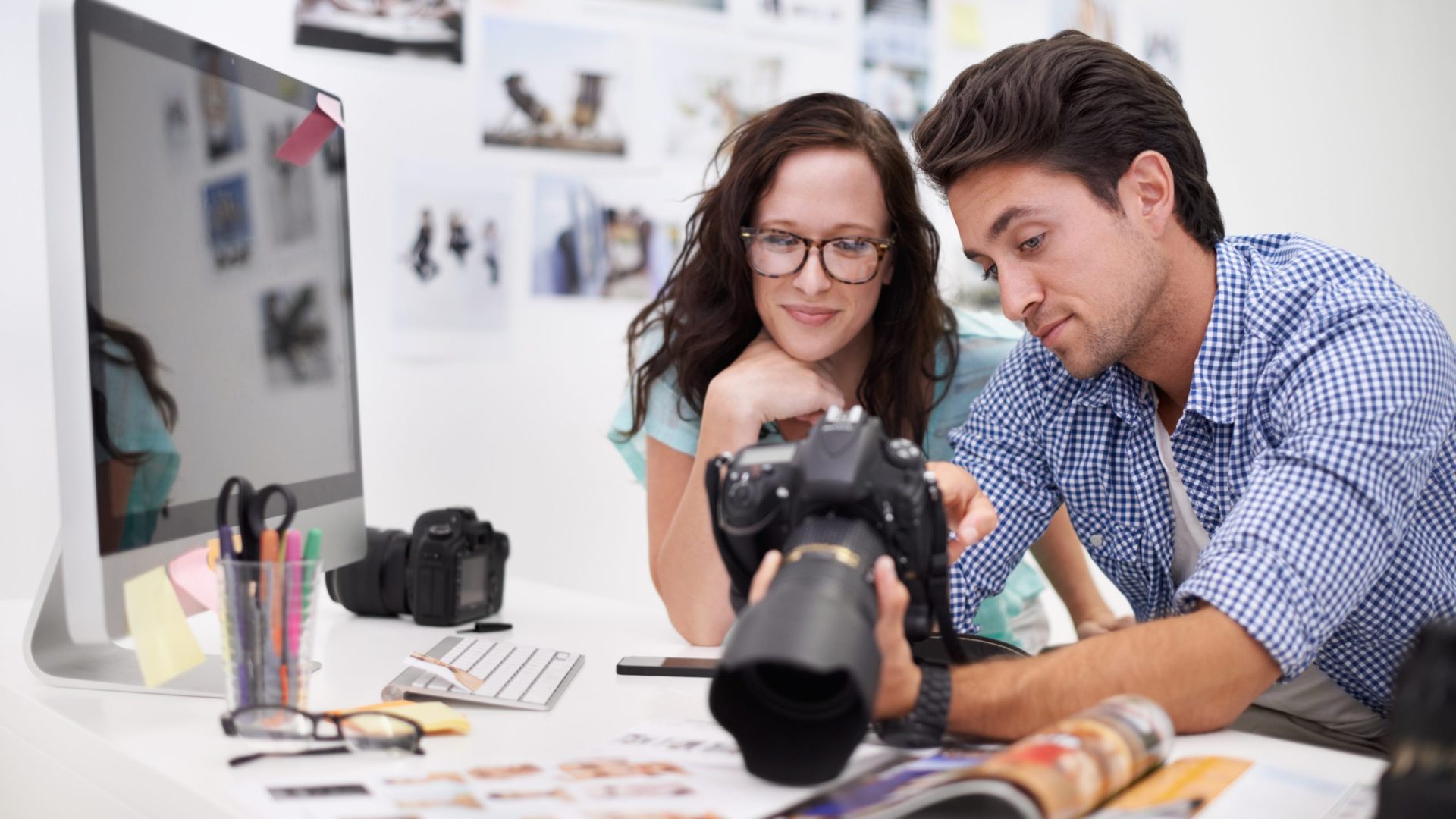 photographer and agent looking at photos on a digital camera
