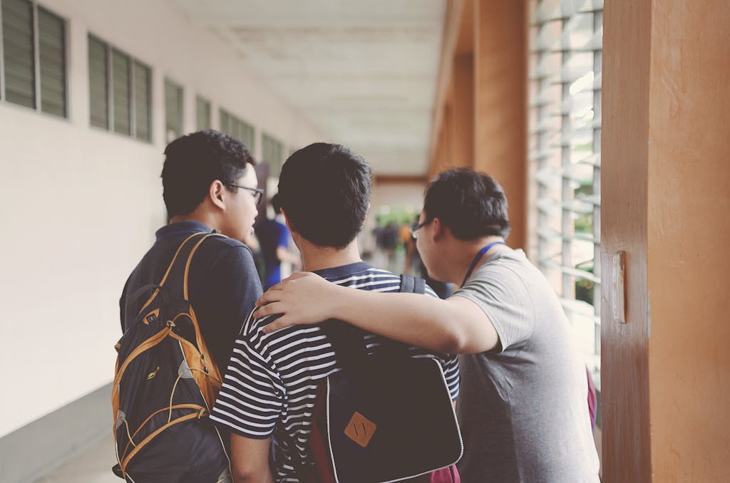 Three Men Standing Near Window school