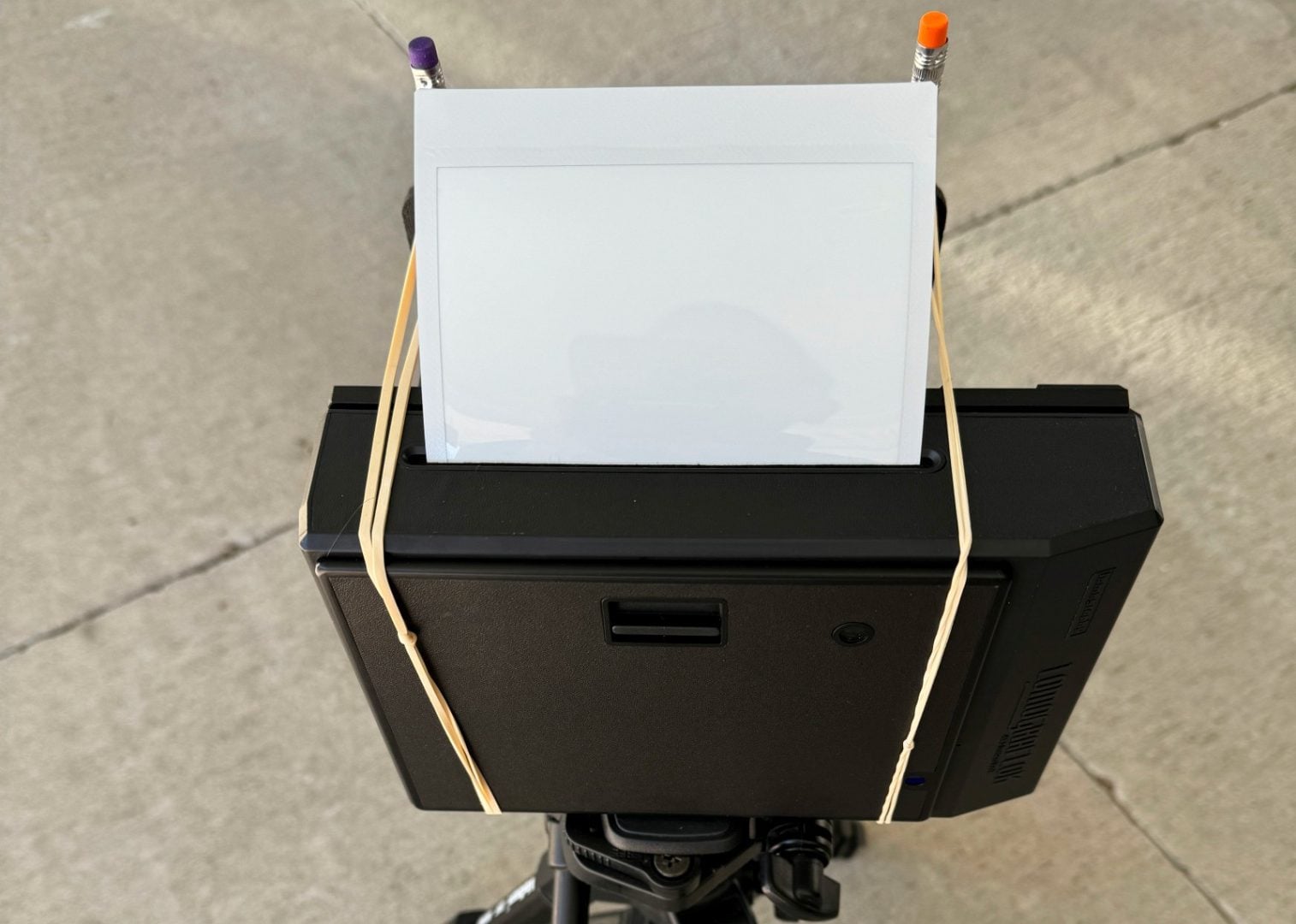 Figure 5. Keep the elastic bands and pencils away from the Instax film ejection slot.
