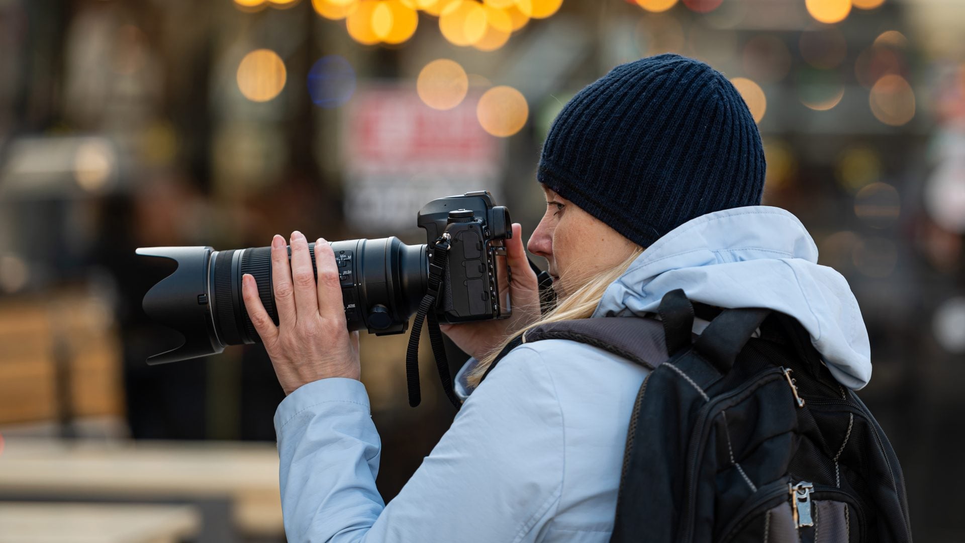 blonde middle-aged female with a camera in the evening on the ci