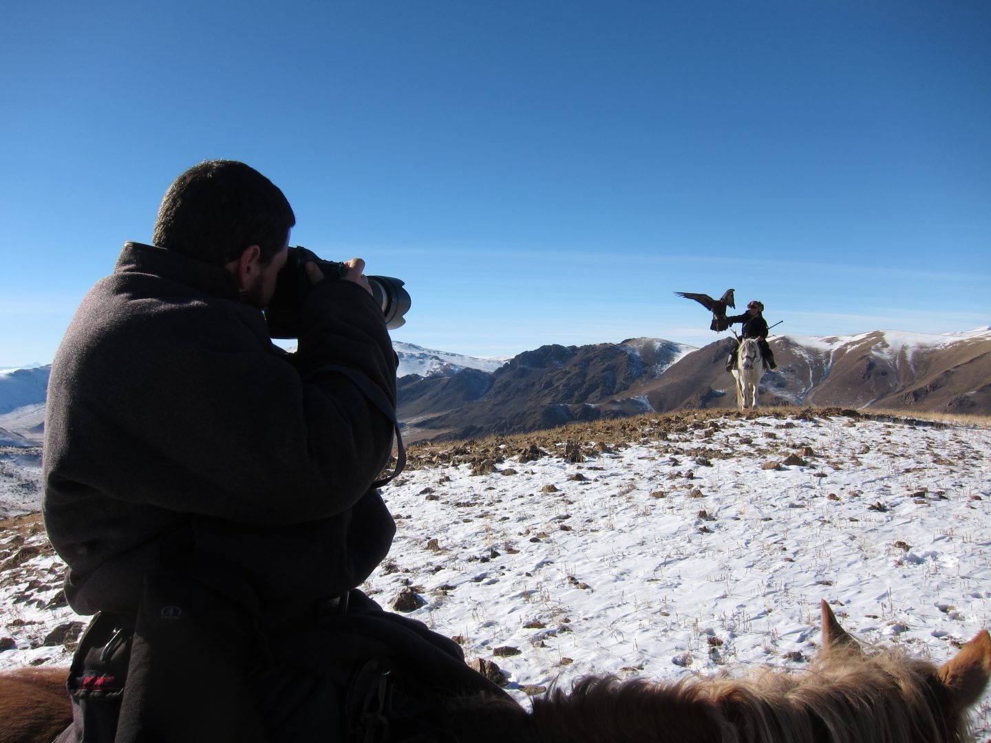 Man taking a picture of a horseman