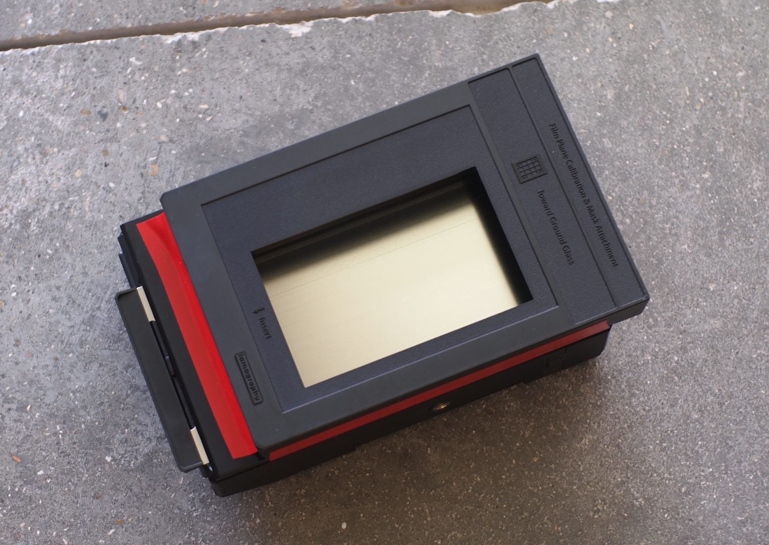Figure 4. Tape the Lomography LomoGraflok back and spacer together. Note: red electrician's tape was used for more clearly showing this step.