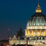 Rome, Italy. Close Up View Dome Of Papal Basilica Of St. Peter In Vatican In Evening Night Illuminations.