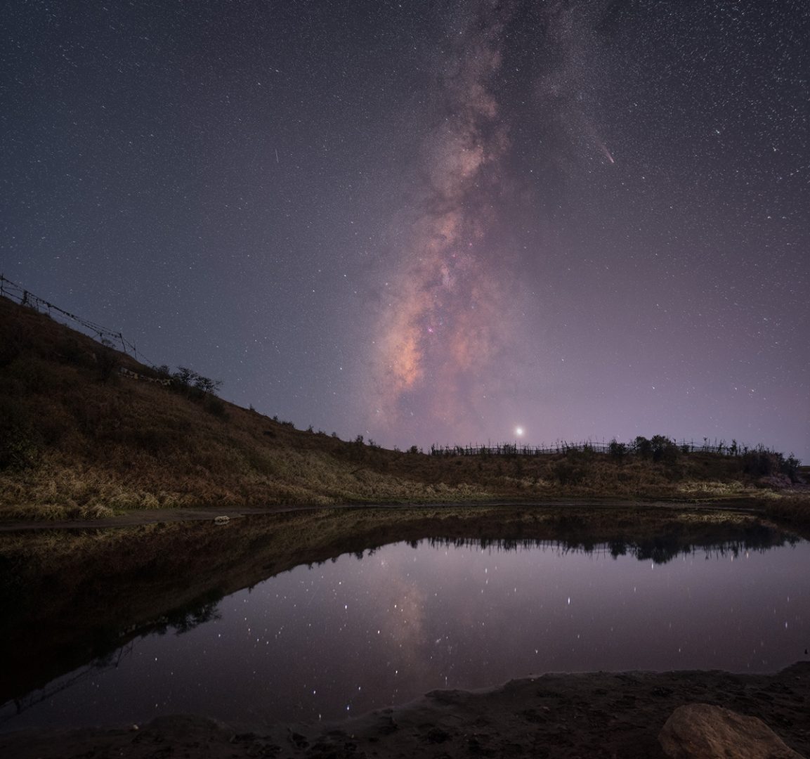A blend of multiple sets of exposures. One set of images for the sky, one set for the foreground, and a single exposure for the reflection