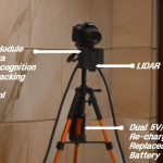 A robotic AI cameraman setup on a tripod, featuring a CPU vision module, video camera, AI object recognition and tracking, built-in WiFi, LIDAR sensor, motor control, firmware, and a dual 5V/12V rechargeable, replaceable battery