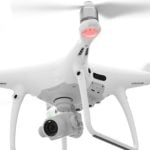 DJI Phantom 4 Pro drone in flight, featuring a mounted 4K camera and red and green LED lights on the propeller arms