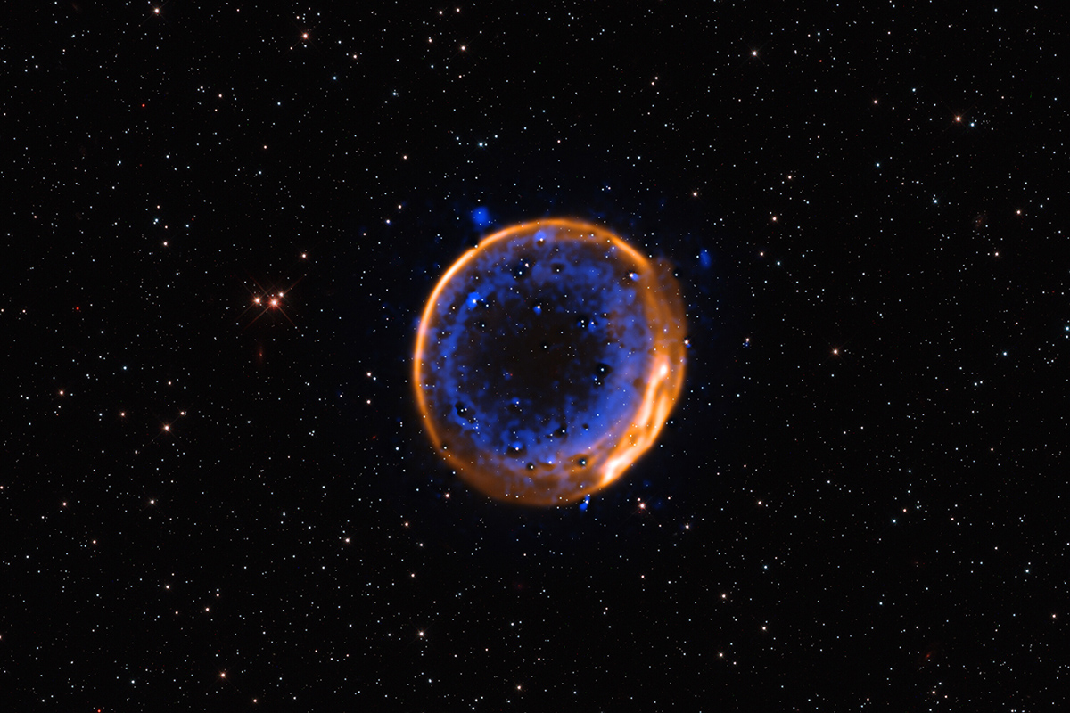 This image, taken with ESO’s Very Large Telescope (VLT), shows the supernova remnant SNR 0509-67.5. These are the expanding remains of a star that exploded hundreds of years ago in a double-detonation, the first photographic evidence that stars can die with two blasts. Credit: ESO/P. Das et al. Background stars (Hubble): K. Noll et al.
