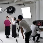 A professional photo shoot in a studio with lighting equipment, reflecting the setup for capturing a subject with controlled lighting.