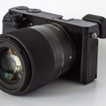 A close-up shot of the Fujifilm X-T4 mirrorless camera, highlighting its compact design and advanced lens features, set against a clean white background.