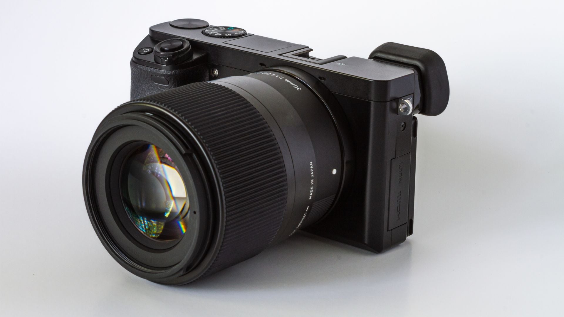 A close-up shot of the Fujifilm X-T4 mirrorless camera, highlighting its compact design and advanced lens features, set against a clean white background.