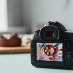 A close-up of a camera display screen showing a beautifully arranged plate of food, ready for a food photography shot.
