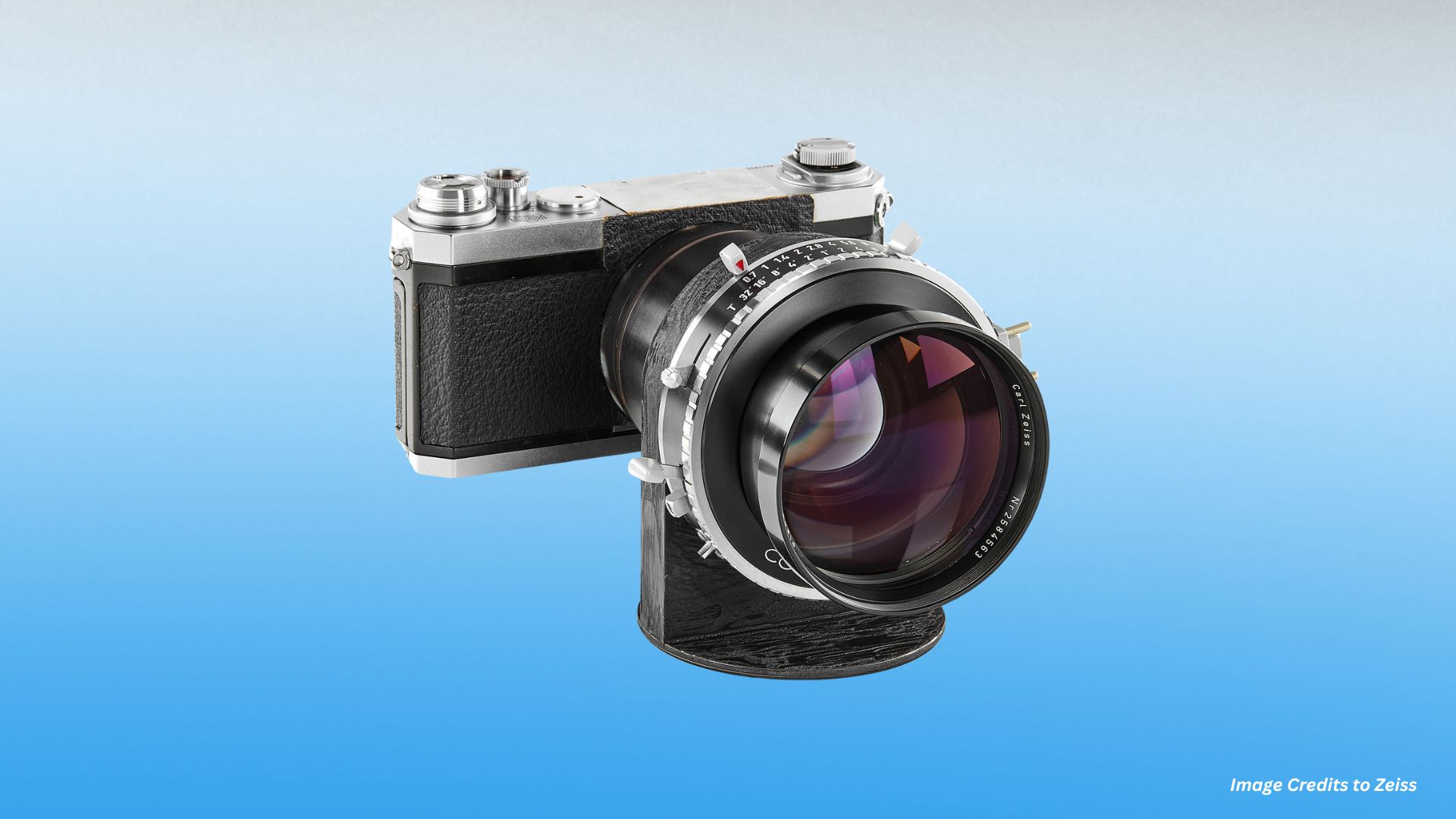 Close-up of a vintage camera equipped with a legendary Zeiss lens, showcasing the premium craftsmanship that defines classic photographic glass.
