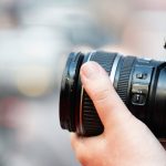 Close-up shot of camera with focus on lens, ideal for product photography.