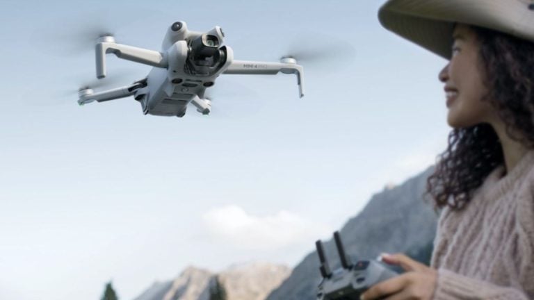 Woman Operating DJI Mini 4 Pro Drone with Remote Controller