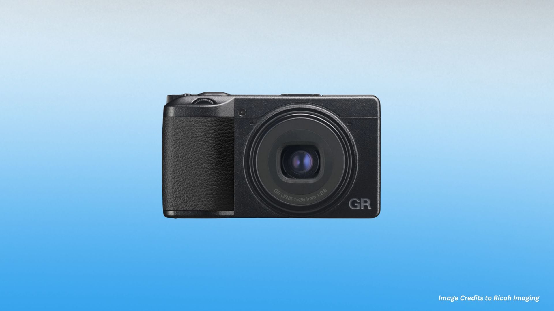 A Ricoh GR IIIx camera held by a person, focusing on its compact size and powerful lens, perfect for capturing high-resolution images in any setting. The background features an urban environment, illustrating its use for travel and street photography.