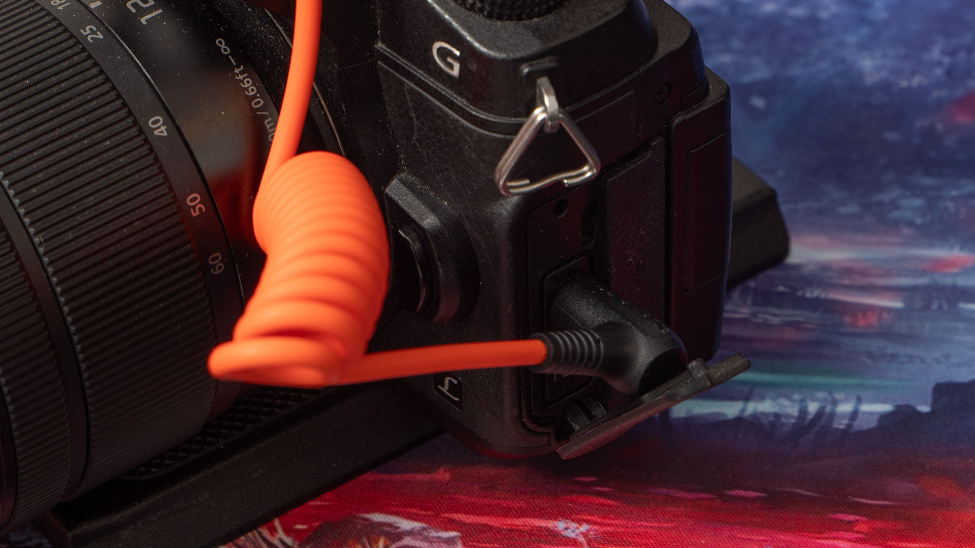 The other end of the Saramonic 3.5m TRS locking cable plugged into a Panasonic Lumix mirrorless camera.
