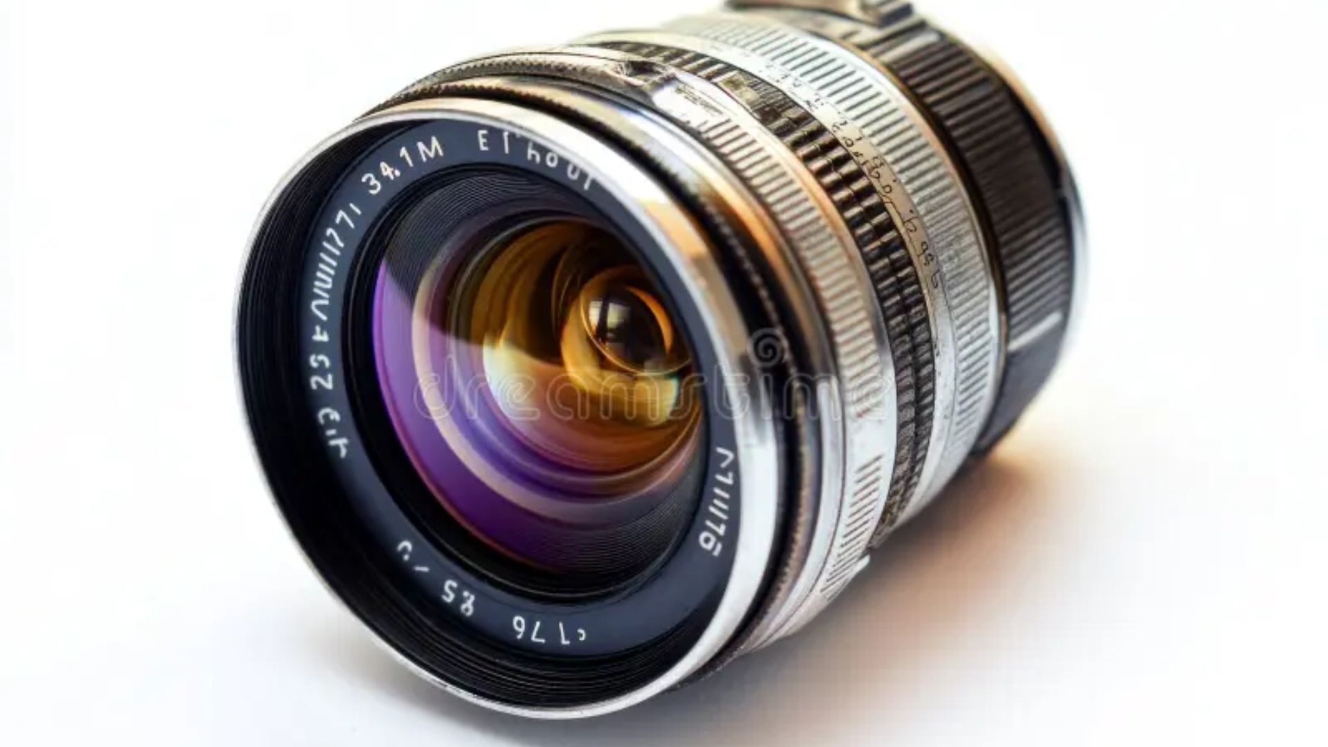Classic silver and black camera lens with purple anti-reflective coating on front element and detailed aperture markings on metal barrel.