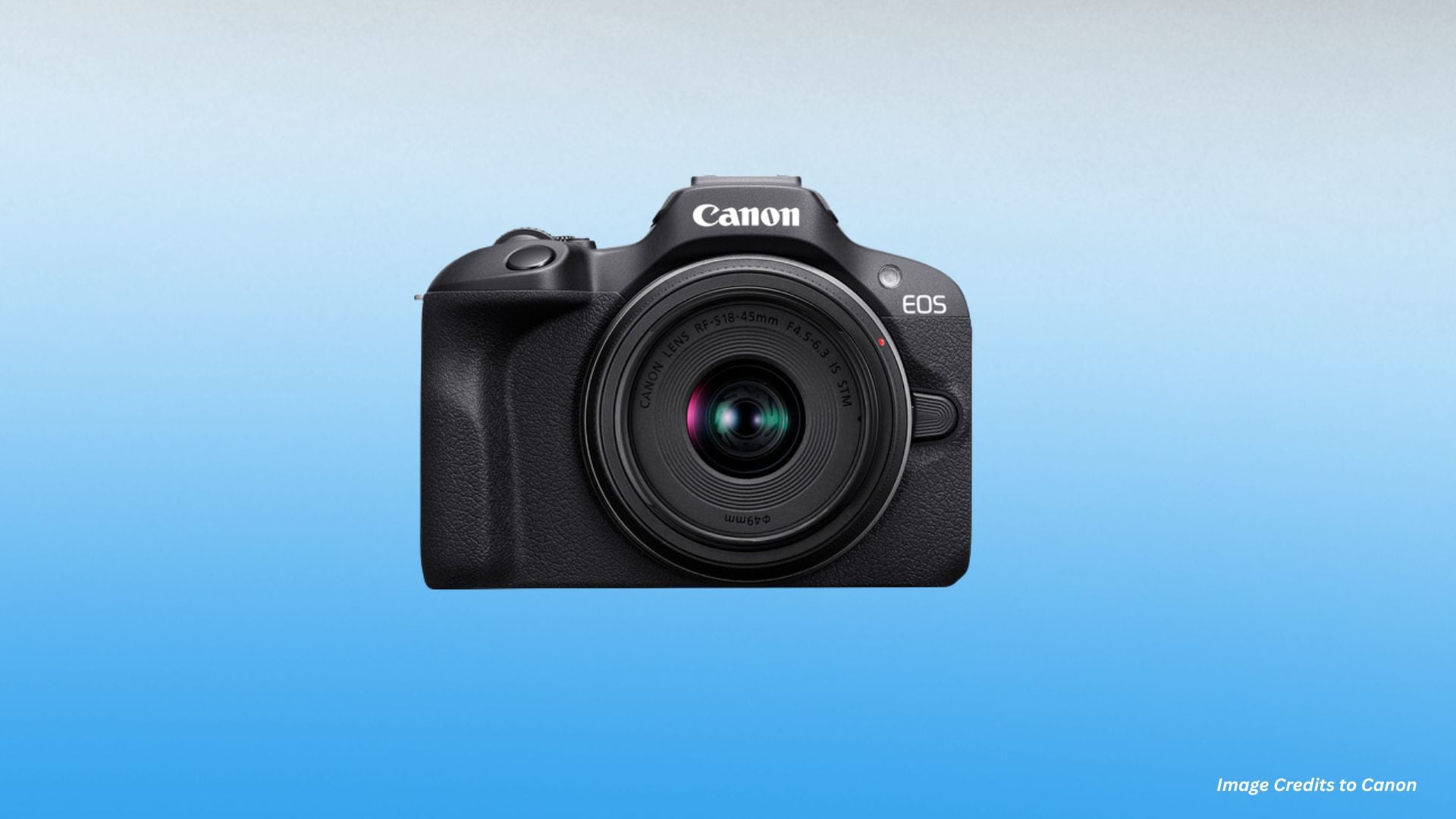 Black Canon EOS R100 mirrorless camera with RF-S 18-45mm kit lens mounted showing front view with textured grip on blue gradient background.