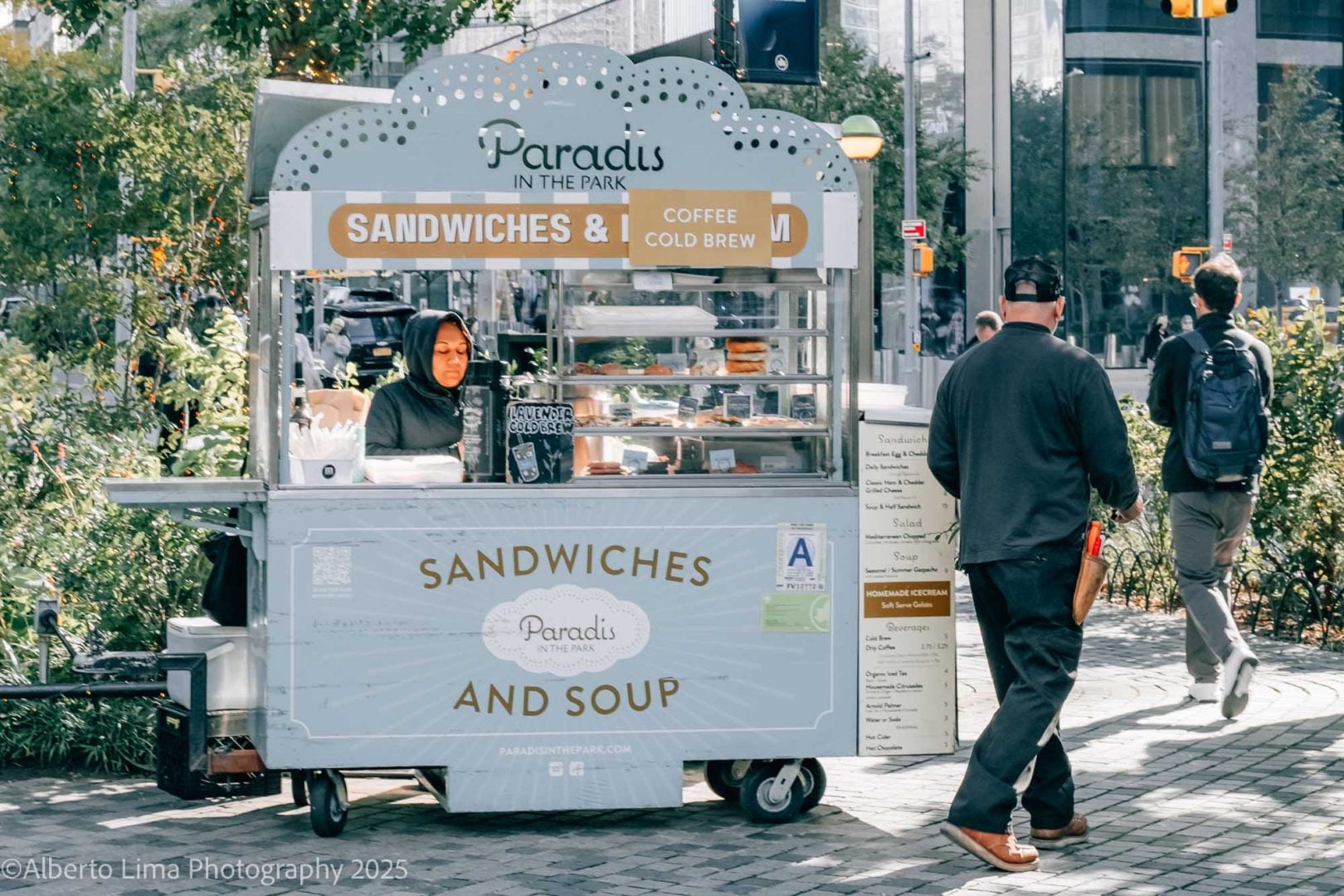 A woman at a sandwich stall. 