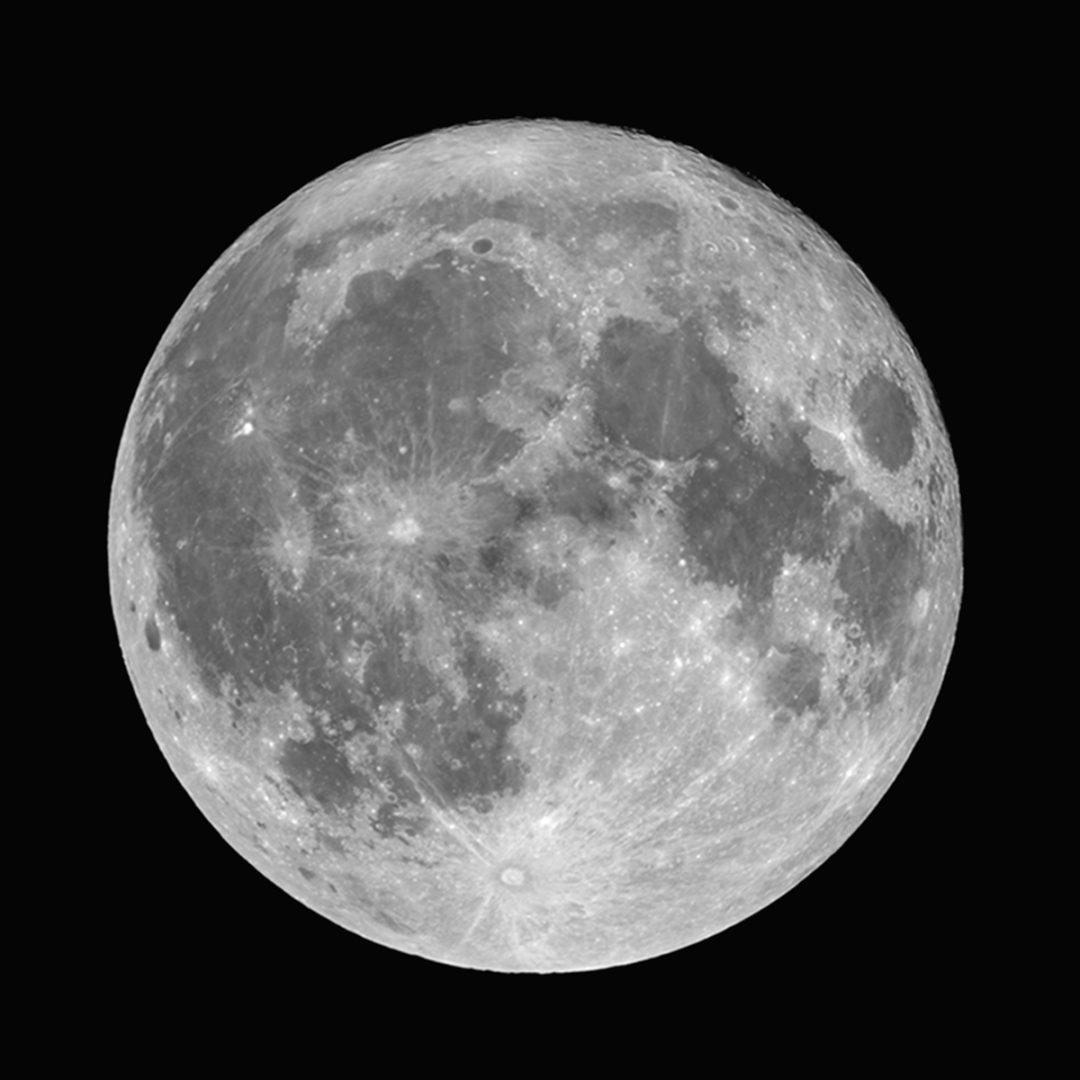 A full moon looks surreal in the night sky