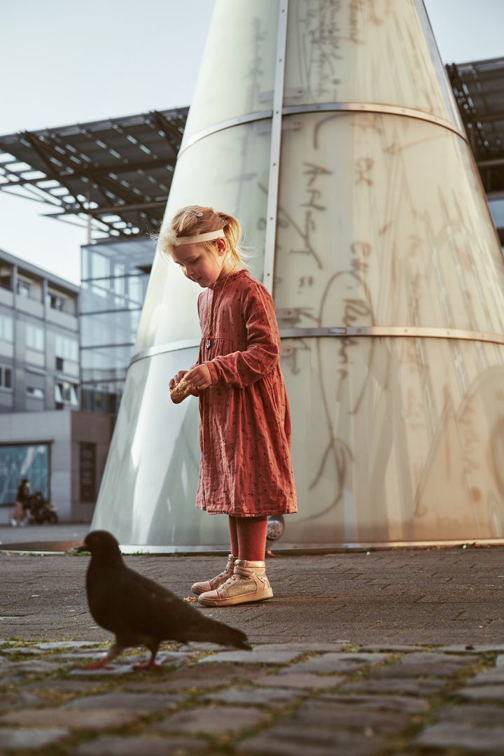 girl feeding pigeons