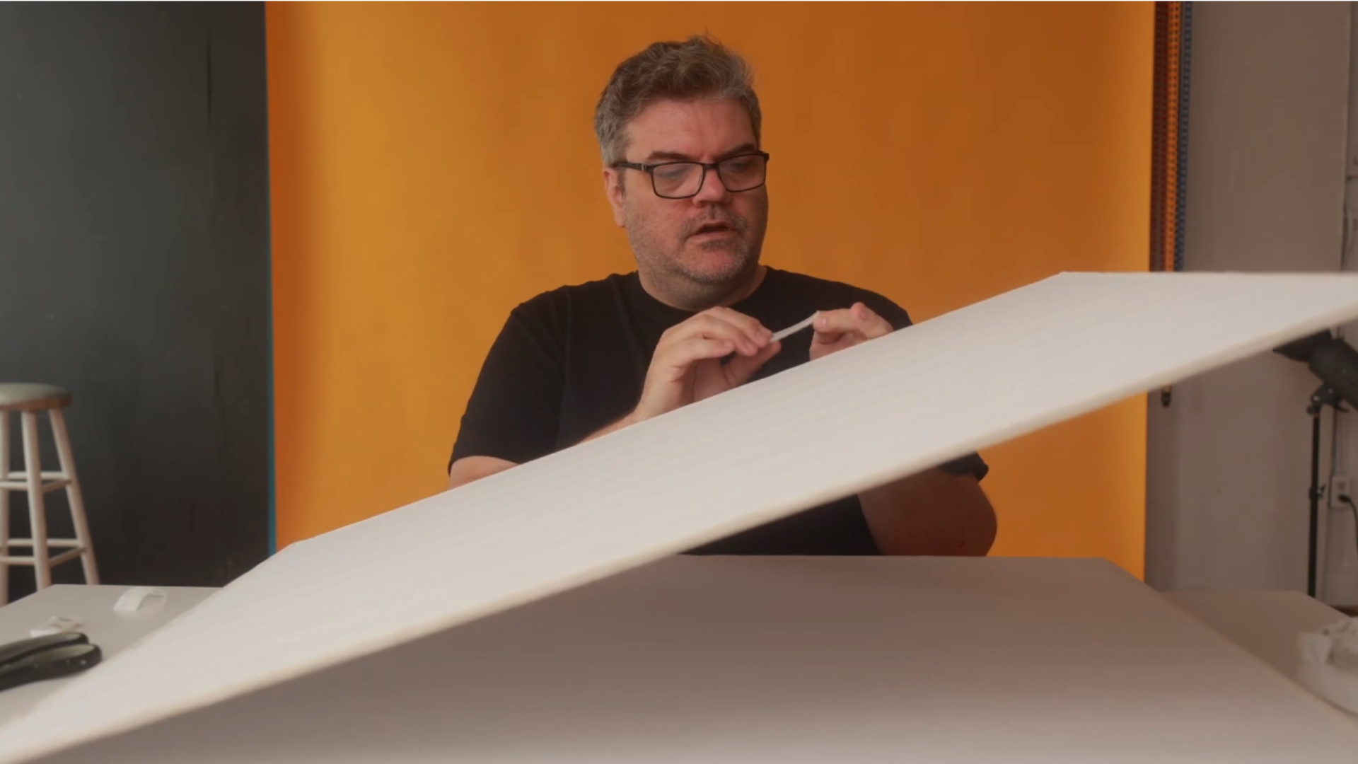 A guide to attaching Velcro closures to the DIY V-flat, making it easy to assemble and disassemble for portability and quick adjustments in your photography setup.