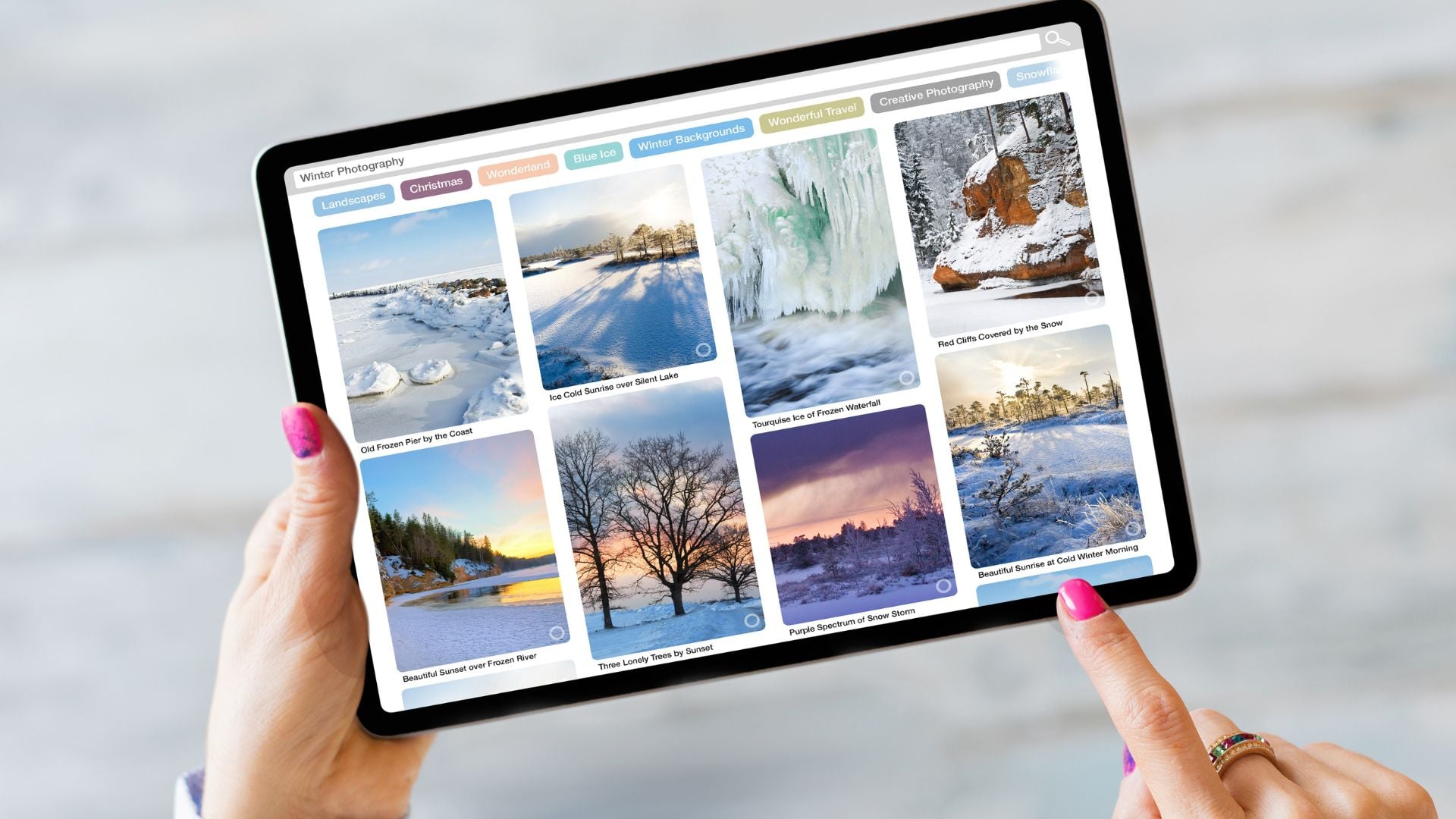 Tablet screen showing curated Pinterest board with winter landscape photography images organized by category tags and keywords for creative planning