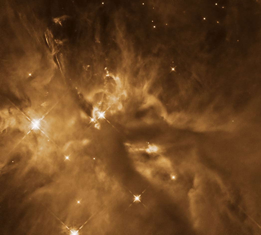 Protostar HOPS 181 is buried in layers of dusty gas clouds, but its energy shapes the material that surrounds it. Credit: NASA, ESA, and T. Megeath (University of Toledo); Processing: Gladys Kober (NASA/Catholic University of America)