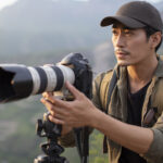 how to take better photos Chinese photographer taking photos outdoors
