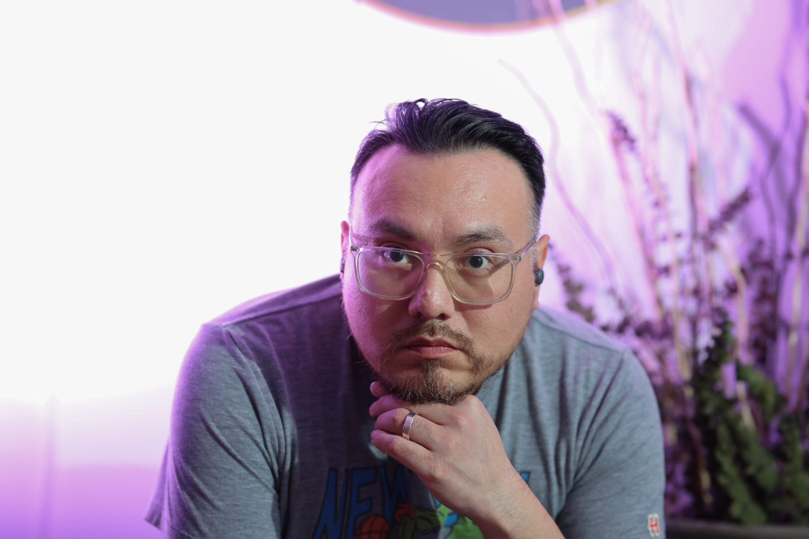 Portrait of a man with glasses against a colored background