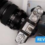 A Fujifilm X-T30 III sits on top of a photobook.