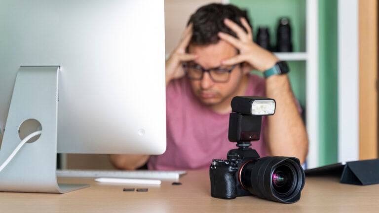 Photographer in his office worried about his photos on the computer