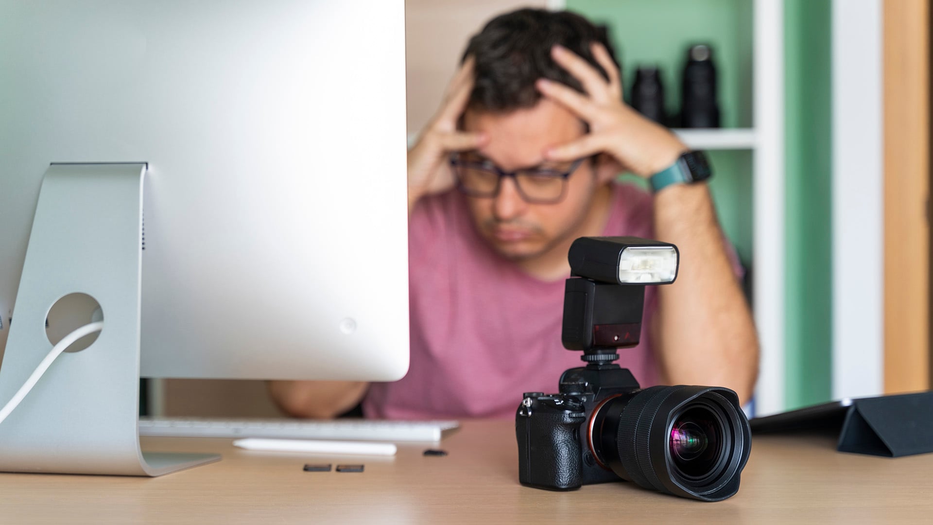 Photographer in his office worried about his photos on the computer
