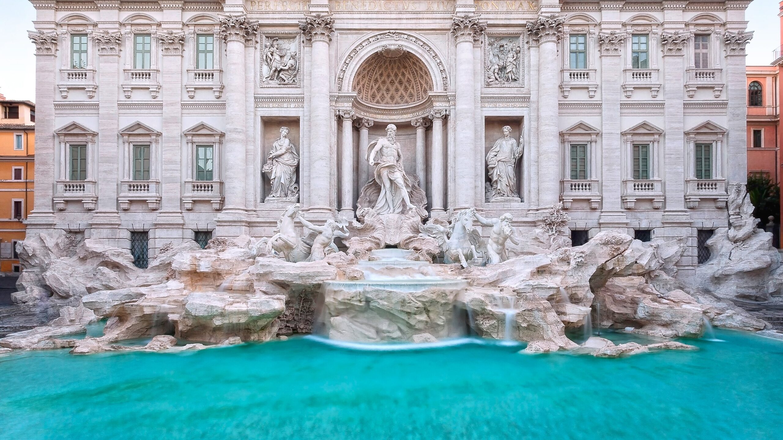The famous Trevi fountain seen from the front. daylight photography with natural light, long exposure to highlight the movement of the water falls.