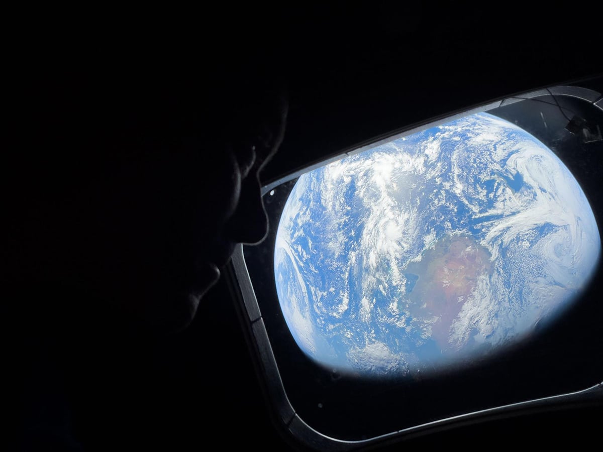 "Thinking of You, Earth". NASA astronaut and Artemis II Commander Reid Wiseman peers out of one of the Orion spacecraft's main cabin windows. Credit: NASA
