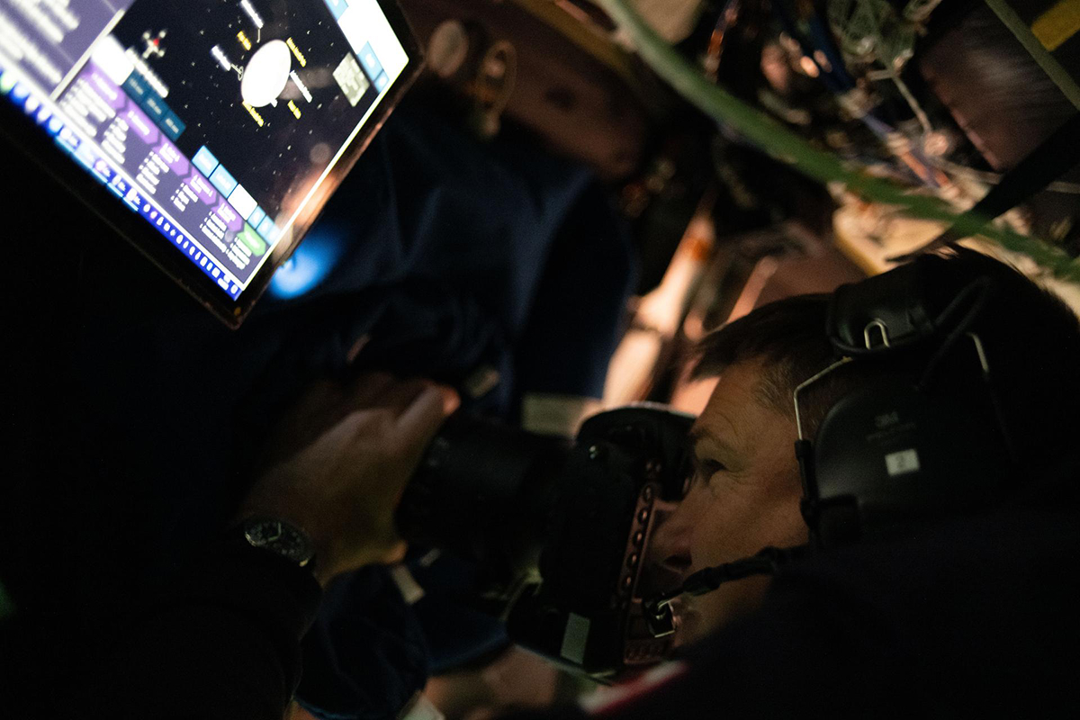 SA (Canadian Space Agency) astronaut and Artemis II Mission Specialist Jeremy Hansen is seen taking images through the Orion spacecraft window during the Artemis II lunar flyby. Credit: NASA