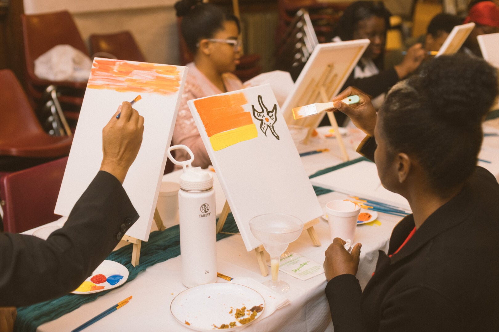 A group painting on a white canvas.