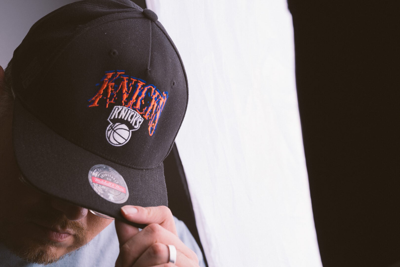 A man with a New York Knicks Cap