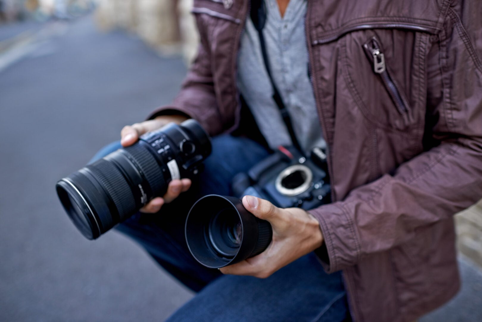 What's the Best Camera for Professional Photography in 2026? photographer changing lenses