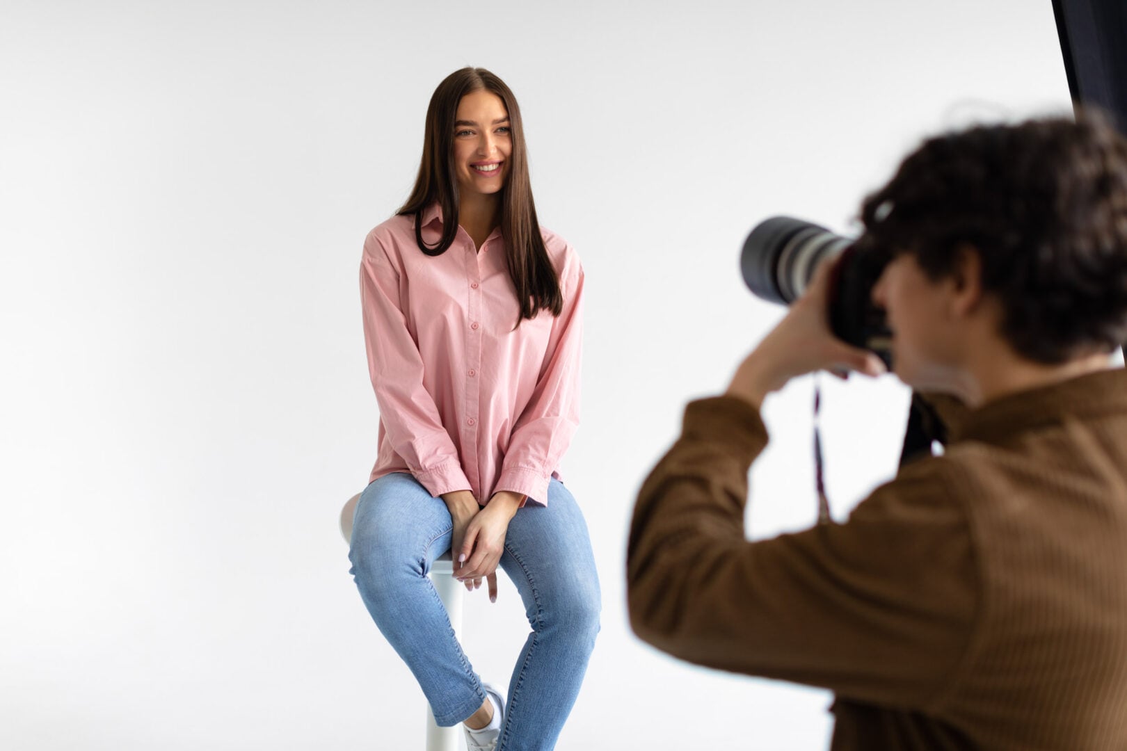 From Products to People: What Is a Commercial Photographer? a man photographing a young woman in a studio