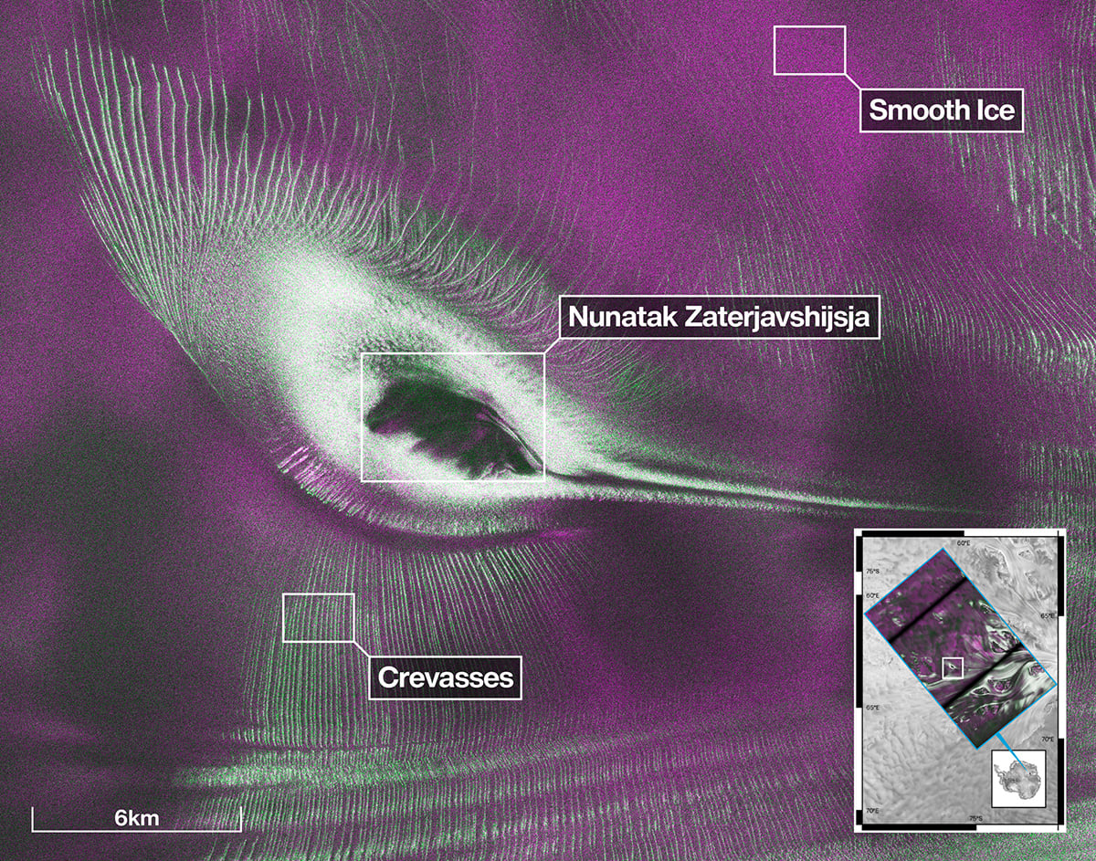 The image shows Nunatak Zaterjavshijsja at center-left, surrounded by ice fractured with crevasses, which are shown as sharp, green lines. The magenta portions of the image represent more regular surfaces, such as smooth ice. Credit: NASA/JPL-Caltech