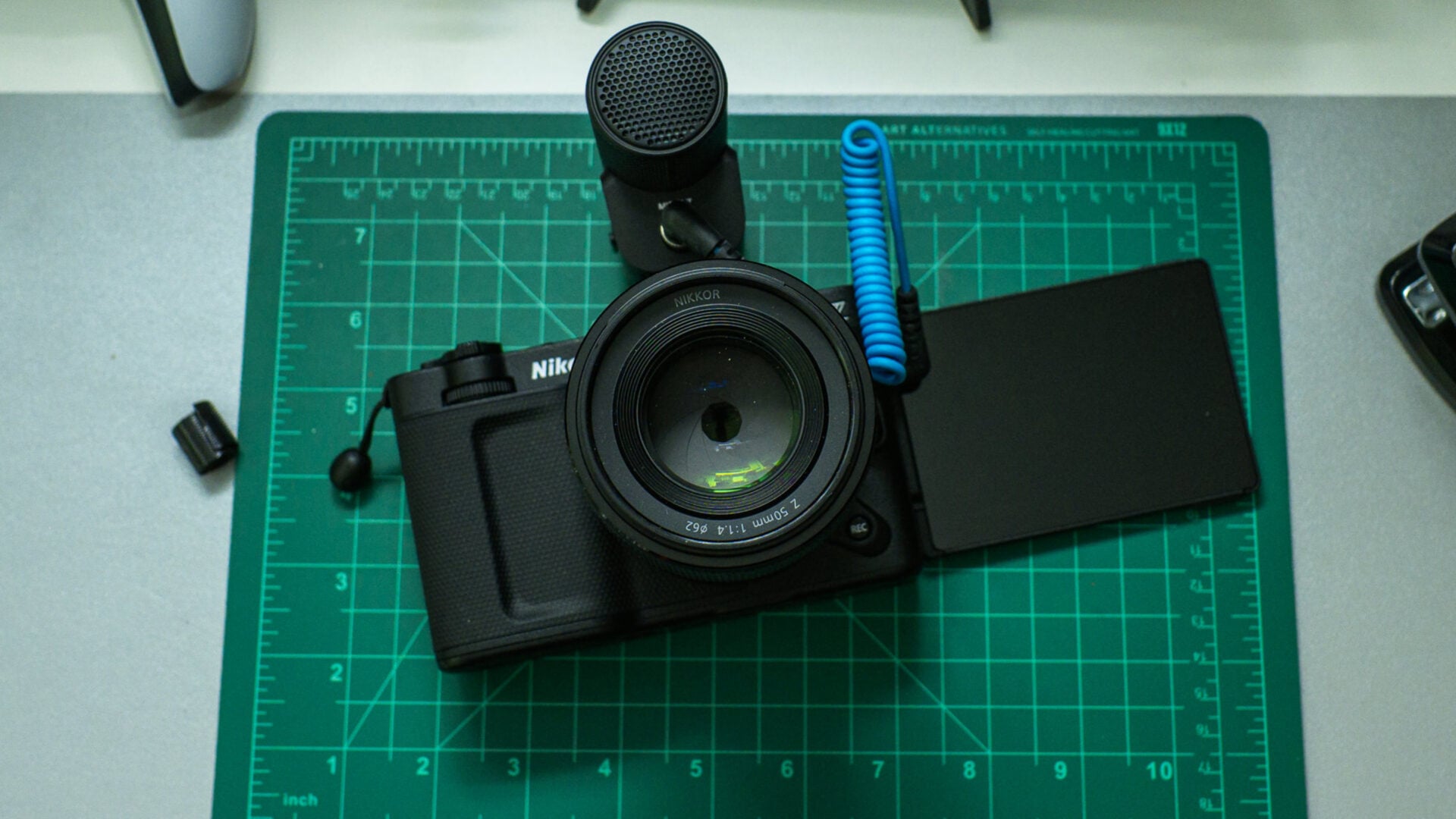 A Nikon ZR with a microphone attached and the flip-out screen extended.