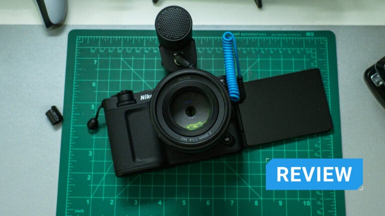A Nikon ZR with a microphone attached and the flip-out screen extended.