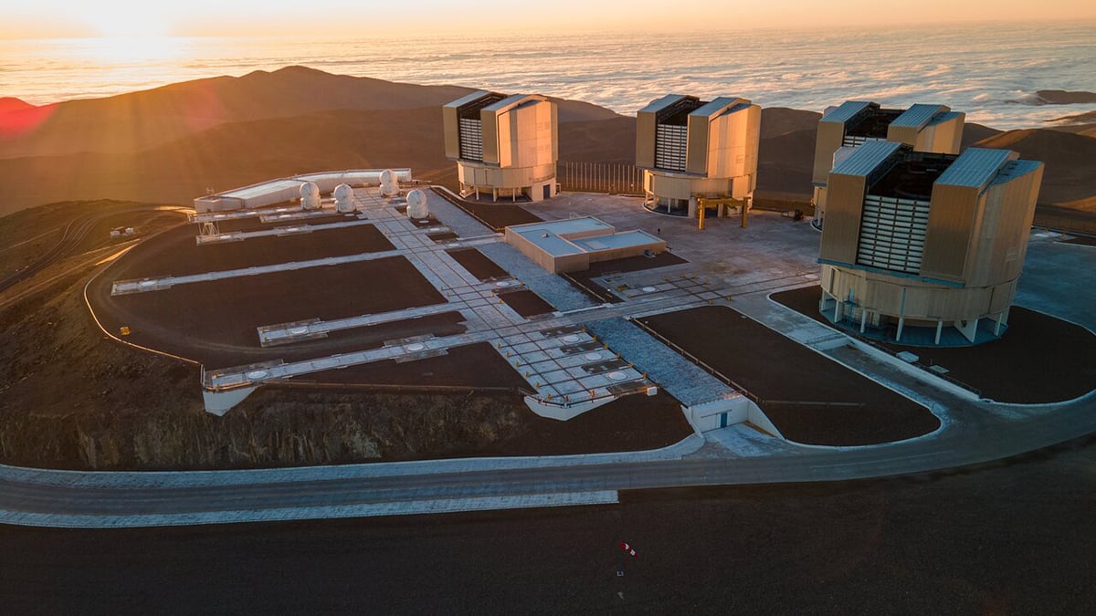 This image shows the four large Unit Telescopes and the four smaller Auxiliary Telescopes that make up ESO’s Very Large Telescope. The Unit Telescope 1, which started operating 25 years ago this week, stands at the center of the image, next to the Auxiliary Telescopes. Credit: ESO