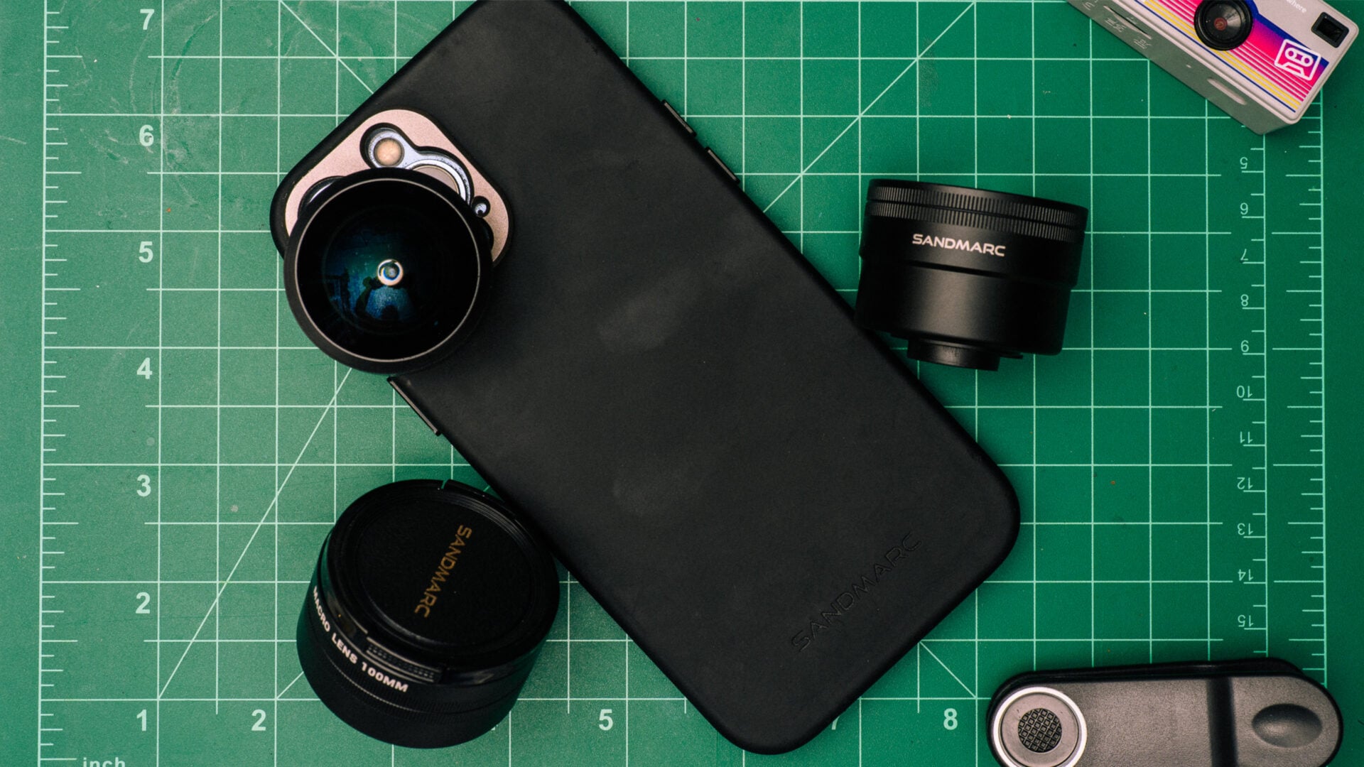 SANDMARC Mobile Photography Kit displayed on a green cutting mat.