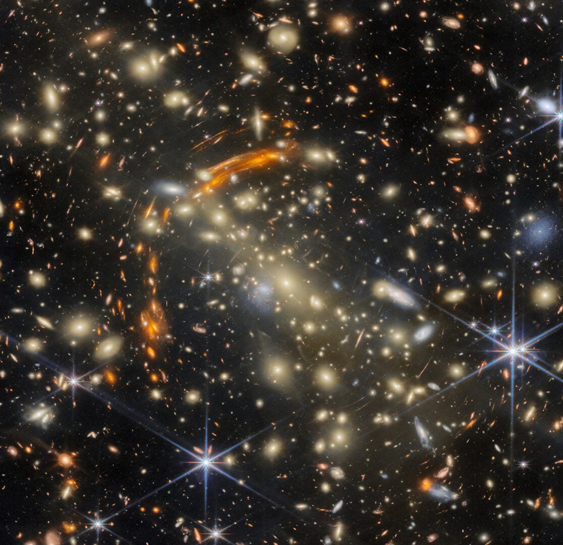 The brilliant golden galaxies splashed across this image belong to a galaxy cluster called MACS J0454.1-0300. Credit: ESA/Webb, NASA & CSA, L. Furtak, S. Fujimoto